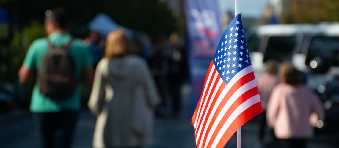 New York, USA, American flag waving on the car on the 4th of July, thanksgiving day or during United States Presidential election, 11 September, with people and cars on background