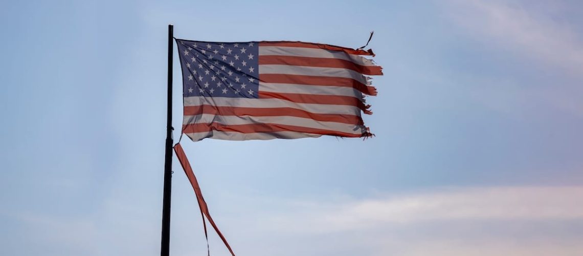 A Weathered and Torn American Flag blowing in the wind