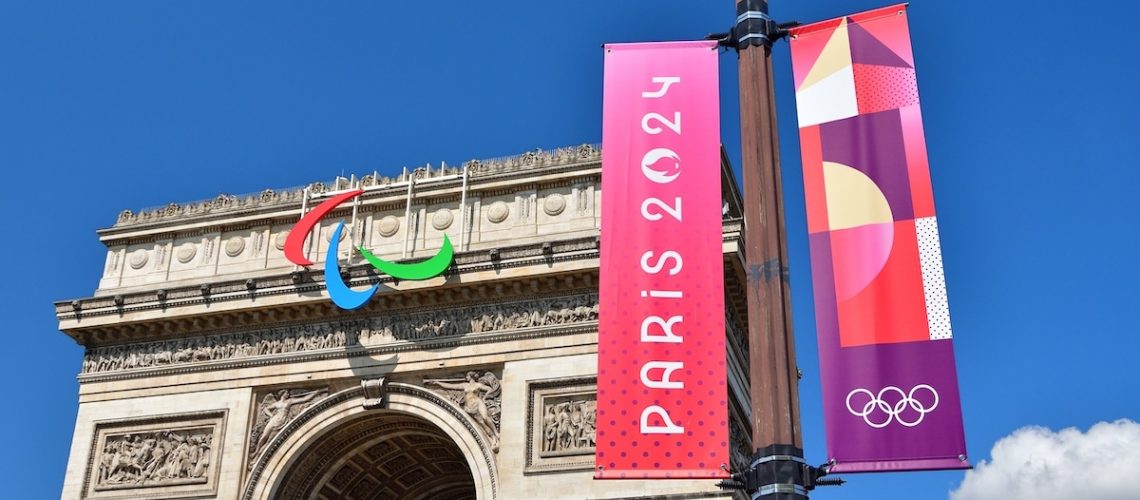 Paris, France. The Arc de Triomphe with the Paralympic symbol attached and the Paris Olympic flag. July 17, 2024.